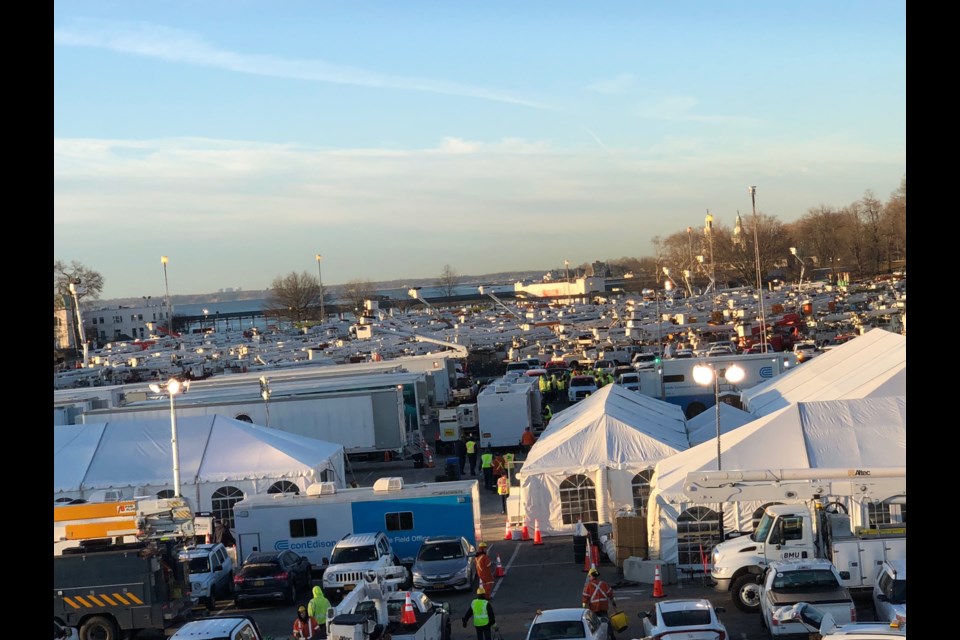 Bucket trucks and other vehicles fill a Rye, N.Y. parking lot (G.Miller)