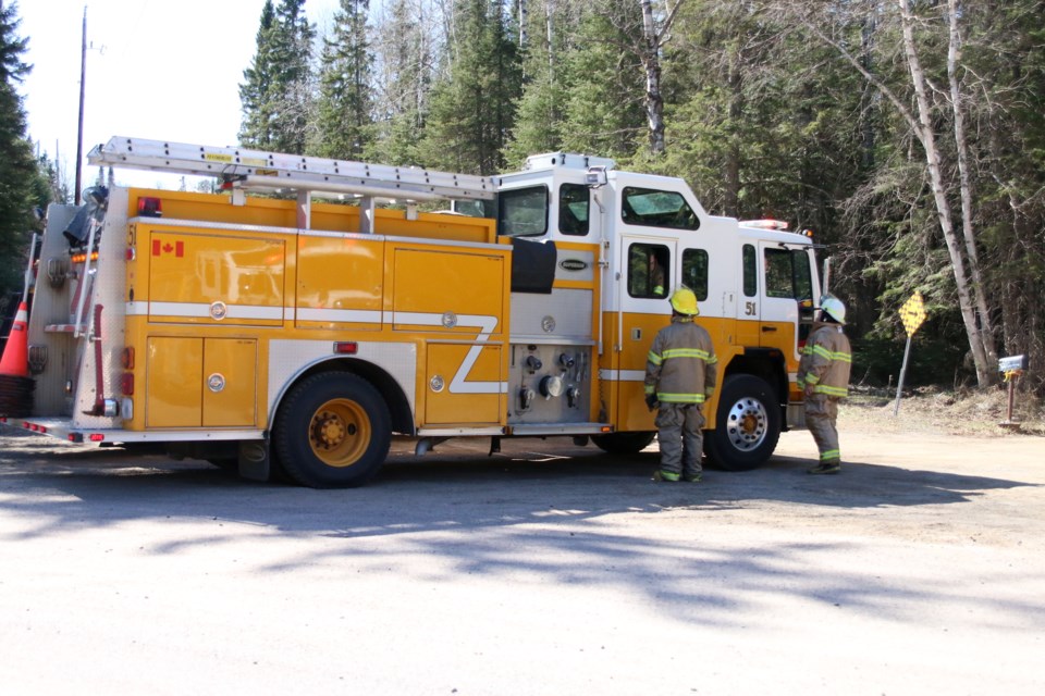 A large grass fire threatened a Copenhagen Road home Sunday afternoon. (Photos by Doug Diaczuk - Tbnewswatch.com). 