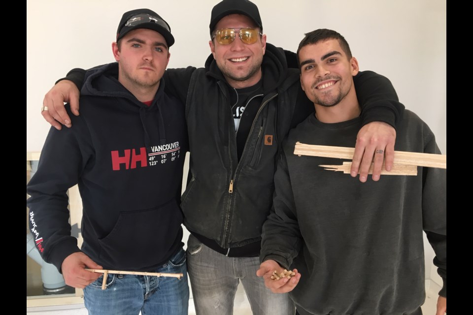 Winning team of the Bridge Design-Build Competition hold the remains of their bridge which collapsed after bearing a load of 54 kg (l-r) Chris Zysko, Paul Zysko and Trenton Woodbeck (Photo courtesy of Confederation College)