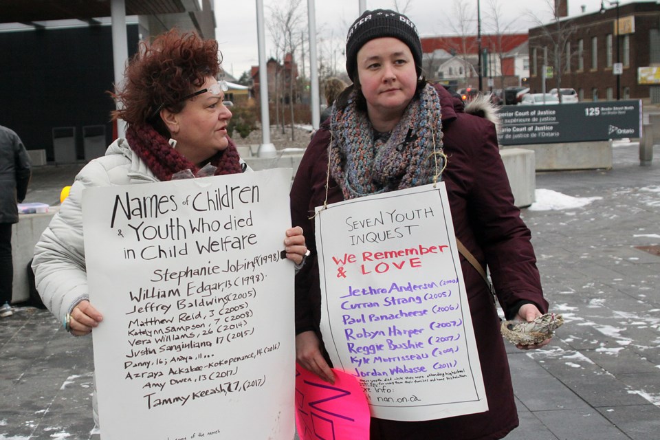 Kim Ducharme (left) and Debbie Jensen were among those protesting the provincial government's decision to eliminate the Ontario child and youth advocate's office outside the Thunder Bay Courthouse on Thursday, November 29, 2018. (Matt Vis, tbnewswatch.com)