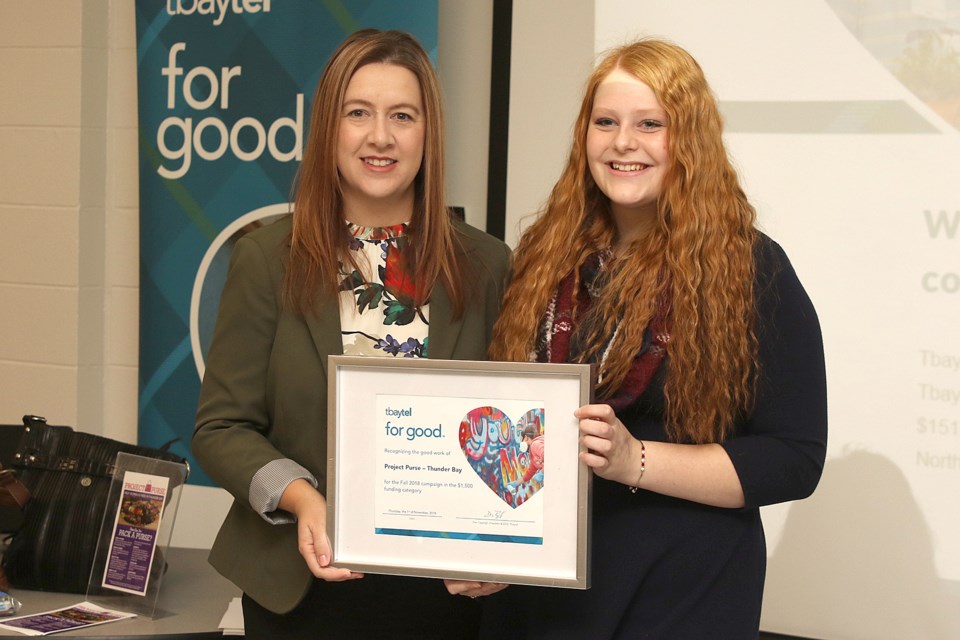 Westgate Collegiate and Vocational Institute Grade 12 student Faryn Gysen (right) accepts her Tbaytel For Good certificate and $1,500 for her Project Purse initiative. 