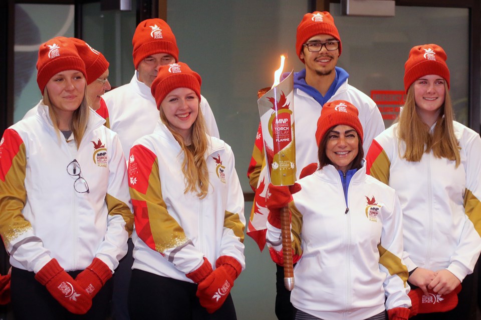 Athletes who took part in the Canada Games torch relay the Canada Games torch on Thursday, Oct. 25, 2018 present the torch at the Canada Games Complex. (Leith Dunick, tbnewswatch.com)