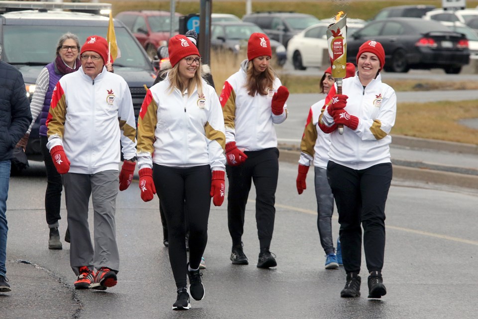 Acting Mayor Shelby Ch'ng carries the Canada Games torch on Thursday, Oct. 25, 2018 at Lakehead University. (Leith Dunick, tbnewswatch.com)
