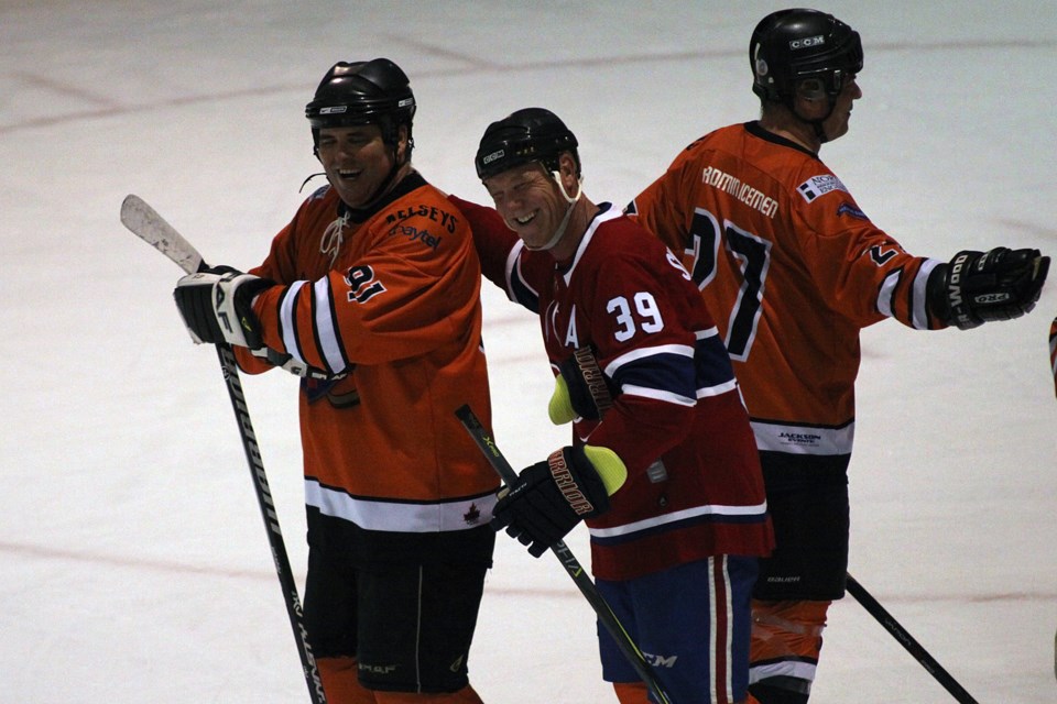 Brian Skrudland enjoys a moment with a teammate during the Easter Seals' Thunder Bay Celebrity Hockey Classic at the Thunder Bay Tournament Centre on Friday, October 26, 2018. (Matt Vis, tbnewswatch.com)