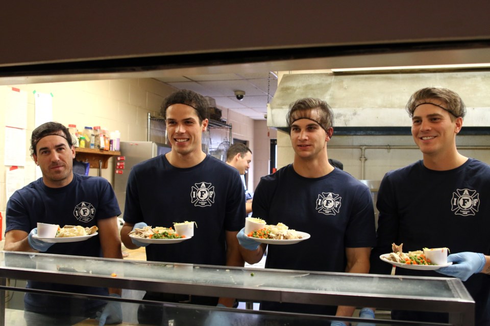 From left to right: Harley Martin, Van Bailey, Justin Grochowski, and Kari Rikkonen serve up a Thanksgiving Day dinner at the Salvation Army on Sunday. (Photos by Doug Diaczuk - Tbnewswatch.com). 