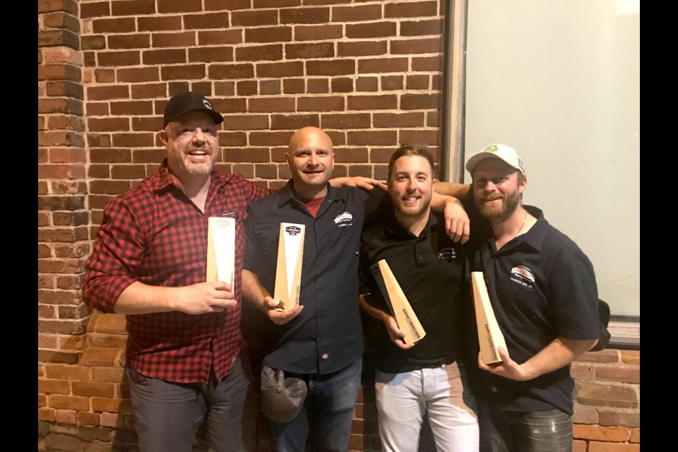 Sleeping Giant Brewing Company president Matt Pearson, head brewer Kyle Mulligan, lead brewer Avery Henderson and general manager Kevin Brewer show hardware won at the Ontario Brewing Awards. (Supplied by Sleeping Giant Brewing Company)