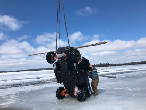 A utility vehicle in danger of sinking on Lake of the Woods was retrieved by helicopter (Forest Helicopters photo)