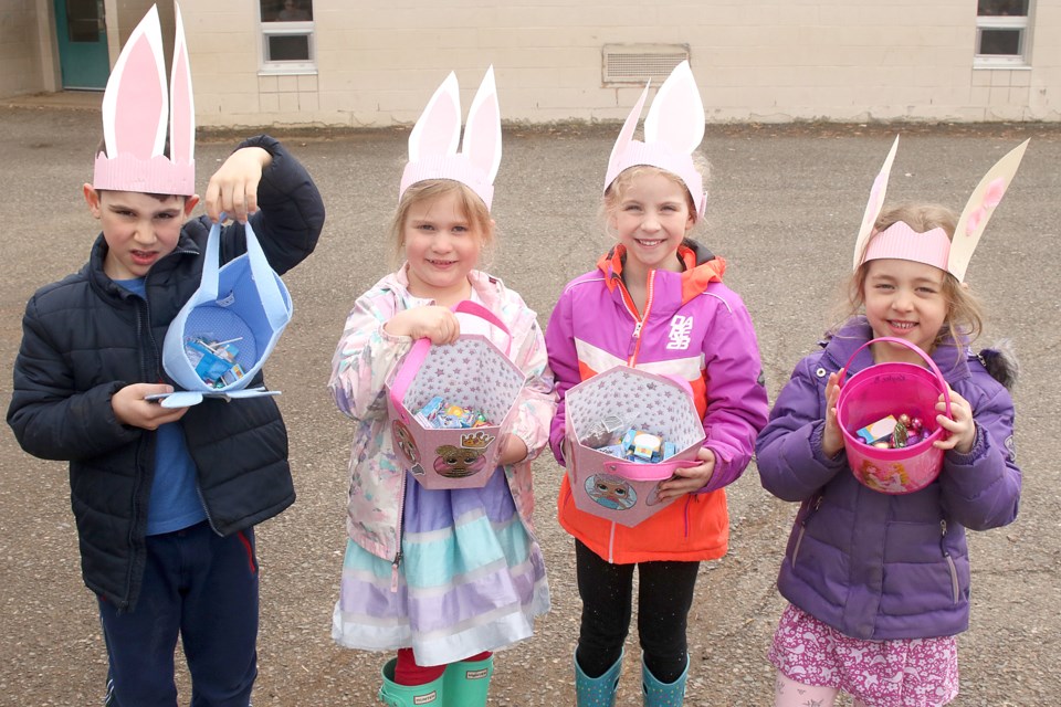 Holy Family school kindergarten students Ryder Olynick (from left), Milania Diebel, Julia Valente and Kaylee Budowski on Thursday, April 18, 2019 show off their Easter egg hunt collection. (Leith Dunick, tbnewswatch.com)
