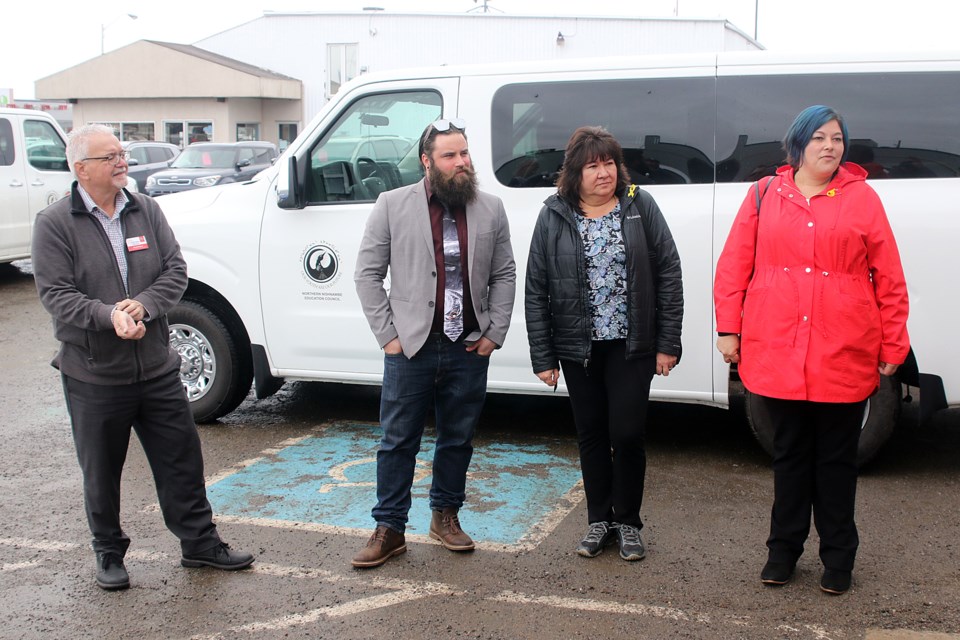Brad Folino (left) of Half-Way Motors, on Friday presented the Northern Nishnawbe Education Council with five vans for use at Pelican Falls First Nation High School. (Leith Dunick, tbnewswatch.com)