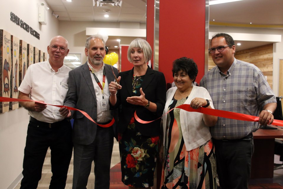 From left to right: Chief librarian, John Pateman, AETS executive director, John DeGiacomo, Minister Patty Hajdu, Sharon Ostberg, president of the AETS Board, and Matthew Dupuis, chief of the Red Rock Indian Band, cut the ribbon to open the AETS centre at the Waverley Resource Library. (Photos by Doug Diaczuk - Tbnewswatch.com).    