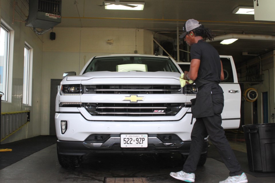 Ruben Bengno wiping the grease off of a Chevrolet. (Michael Charlebois, tbnewswatch)