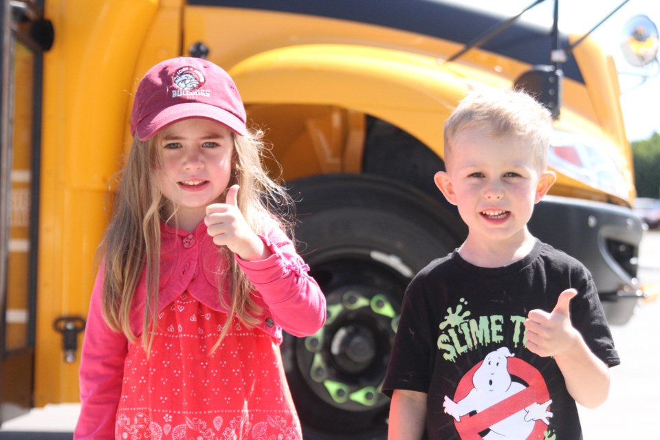 Violet Wright (left) and Lloyd Armstrong ahead of their first school bus ride. (Michael Charlebois, tbnewswatch)