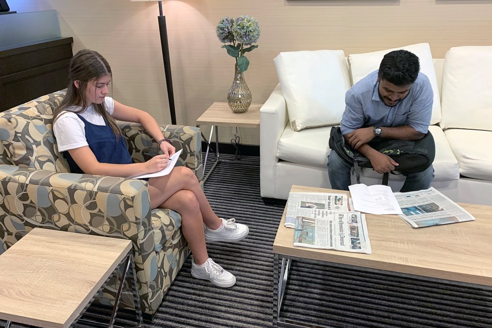 Sofia Fortier (left) and Joel Joe Antony await an interview on Thursday, Aug. 22, 2019, seeking jobs at the soon-to-open Marshall's location at Intercity City Shopping Centre. (Leith Dunick, tbnewswatch.com)
