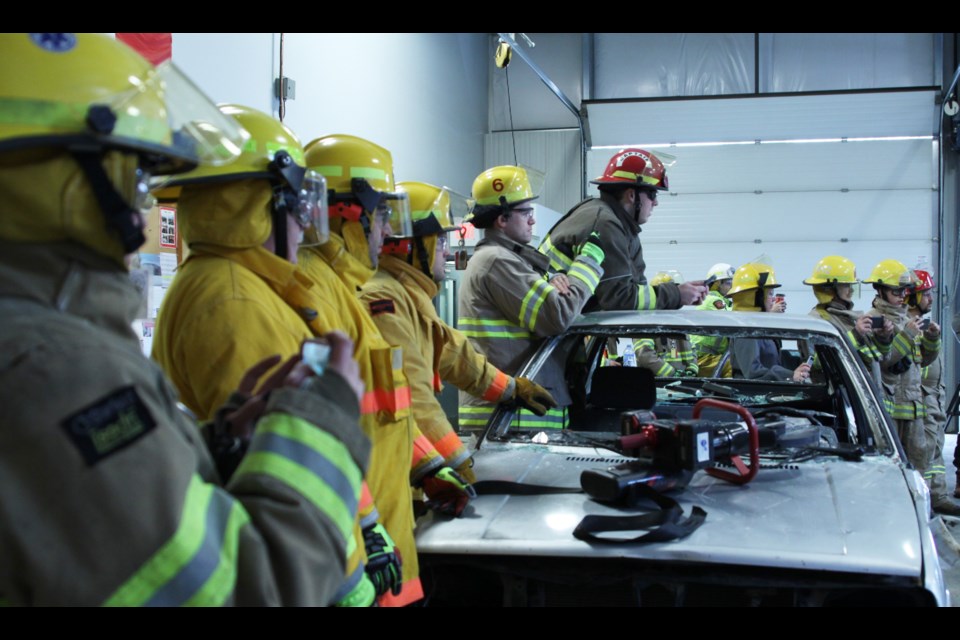 Volunteer firefighters watch a demonstration at this weekend's auto extraction training session in Kakabeka Falls. (Photos by Ian Kaufman/Tbnewswatch.com)