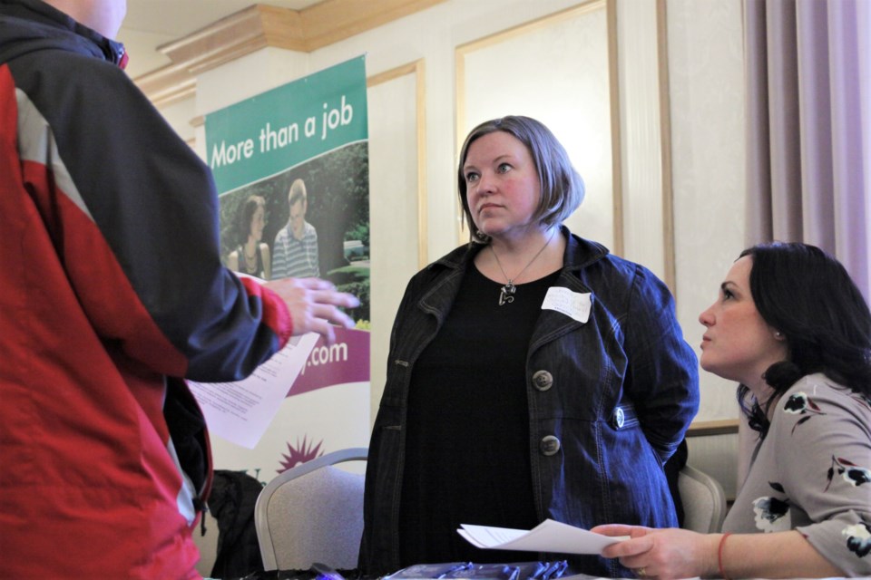 Jennifer Roukkula (left) and Melissa Boban of Ontario Correctional Services speak with a participant in Monday's health care career fair. (Photos by Ian Kaufman, Tbnewswatch.com)