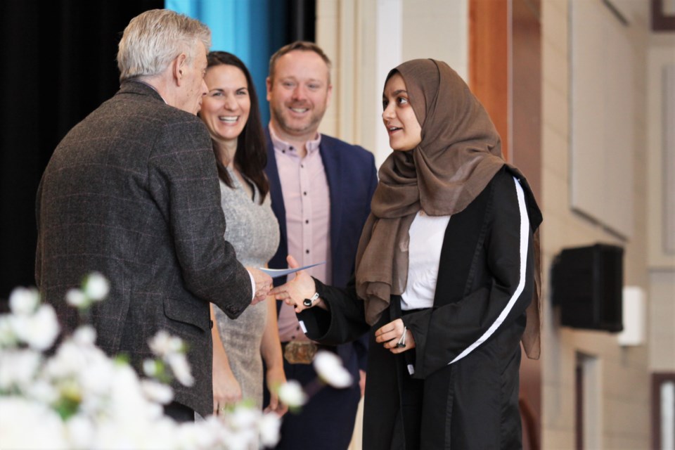 Laila Ikki is congratulated by Lakehead School Board Director of Education Ian MacRae, as she receives her International Baccalaureate diploma. (Photos by Ian Kaufman, Tbnewswatch)