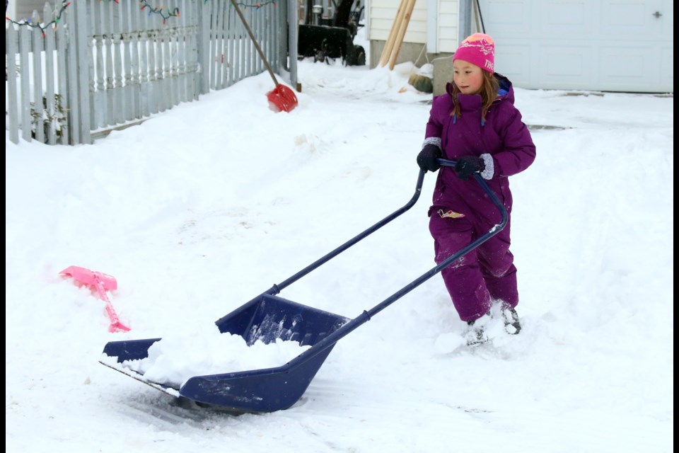 Emmersyn, 8, was out Monday morning helping her dad shovel the driveway after the city received more than 25 centimetres of snow on Sunday and Monday. (Photos by Doug Diaczuk - Tbnewswatch.com). 