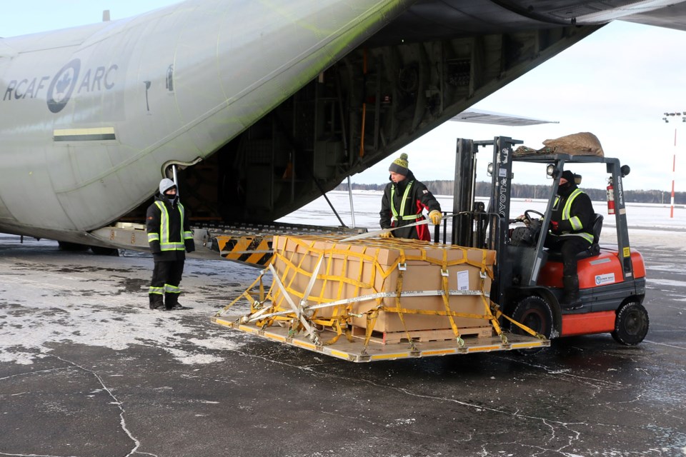 Workers unload crates of toys from a Royal Canadian Airforce Hercules plane. The toys will be distributed to a pair of remote, fly-in communities in Ontario's north. (Leith Dunick, tbnewswatch.com)