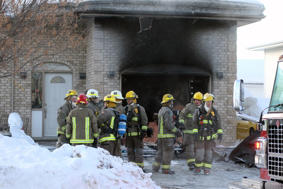 Firefighters respond on Friday, Feb. 1 2019 to a fire that broke out in the garage of a Porcupine Boulevard home. (Leith Dunick, tbnewswatch.com)