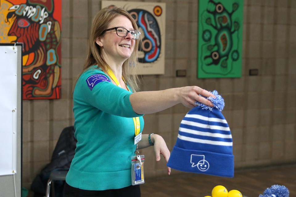 Irene Pugliese, a senior counsellor at Student Health and Wellness at Lakehead University, hands out a Bell Let's Talk toque on Wednesday, Jan. 30, 2019. (Leith Dunick, tbnewswatch.com)