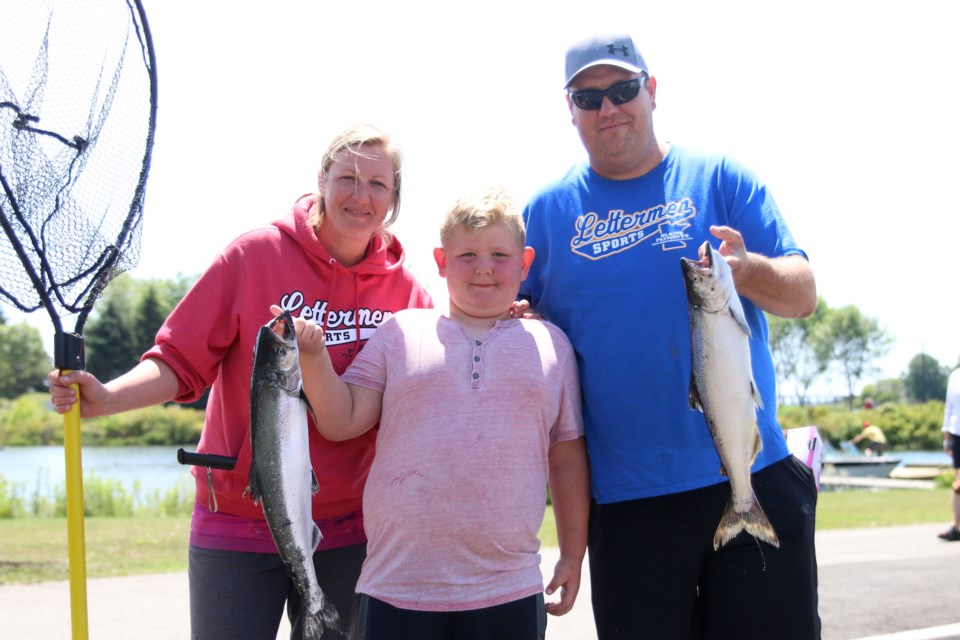 Sam Rojik (left), Carson Wrigley, and Mike Wrigley, hold up their catch of the day during the Thunder Bay Salmon Association Salmon Derby on Sunday. (Photos by Doug Diaczuk - Tbnewswatch.com). 