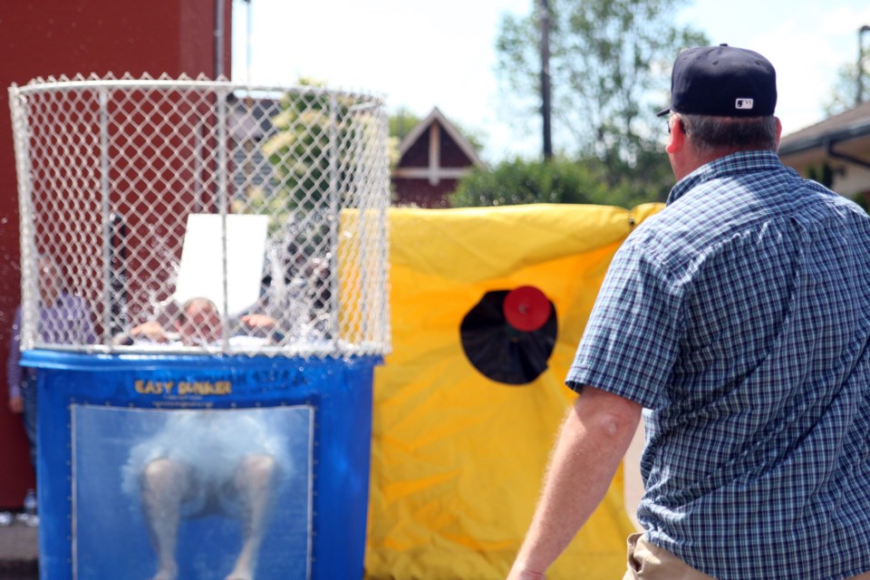 Thunder Bay city councillor, Brian Hamilton, goes for a dunk courtesy of city manager Norm Gale during the Thunder Bay Shelter House Block Park on Saturday. (Photos by Doug Diaczuk - Tbnewswatch.com). 