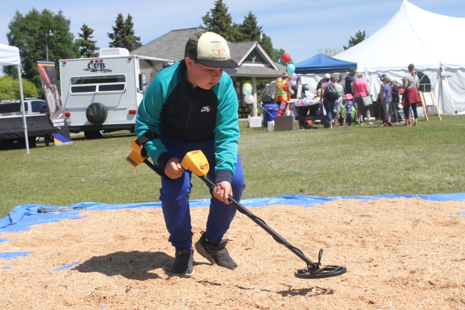 Jayce Anttila searching for treasure at Mining Day on Saturday June 22, 2019. (Michael Charlebois, tbnewswatch)