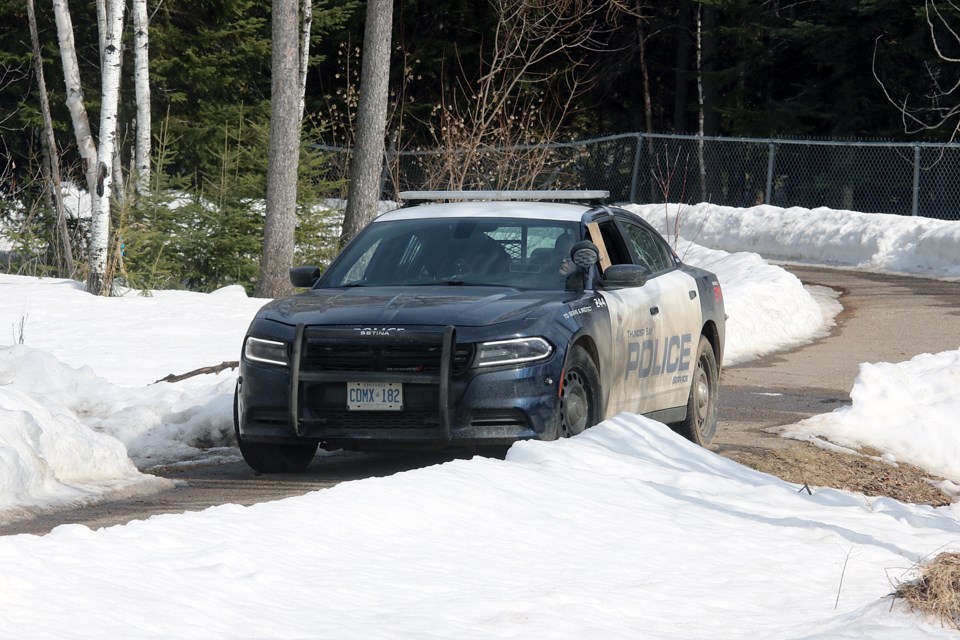 Police on Tuesday, March 19, 2019 guard a murder scene on a pathway near the County Fair area. (Leith Dunick, tbnewswatch.com)