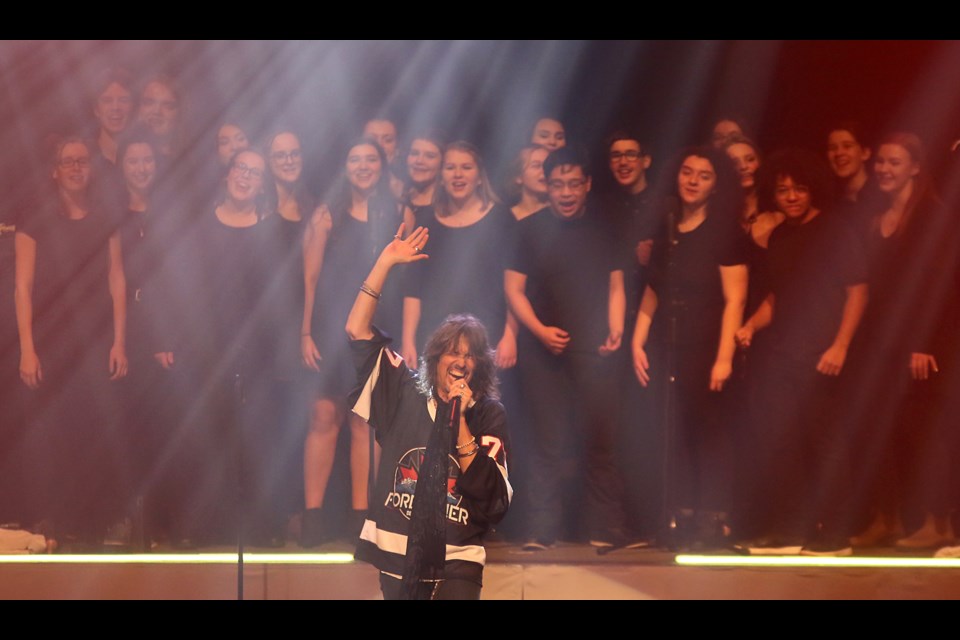 The St. Patrick High School choir on Monday, March 4, 2019 joins Foreigner and vocalist Kelly Hansen on stage for their first encore song, I Wanna Know What Love Is, at the Thunder Bay Community Auditorium. (Leith Dunick, tbnewswatch.com)