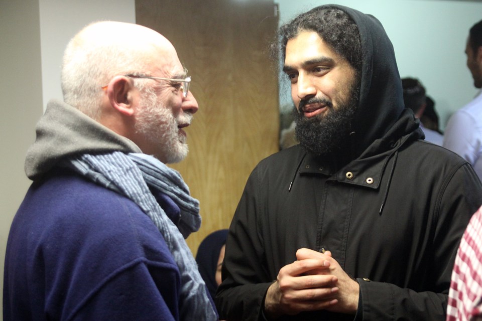 Hikmatullah Sherzad, imam of the Thunder Bay Masjid, speaks to an attendee of a vigil to pray for the victims of the Christchurch, New Zealand mosque shootings on Friday, March 15, 2019. (Matt Vis, tbnewswatch.com)