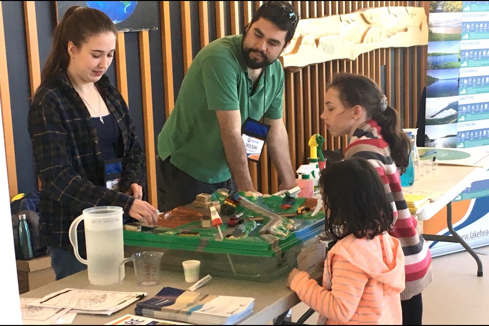 Kids learn about how hazardous materials can enter the watershed through spills and accidents at the Lakehead Region Conservation Authority booth set up at Confederation College on Sunday. 