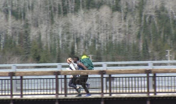 Amazing Race contestants scurry across the bridge at Kakabeka Falls Provincial Park on Monday, May 13, 2019. (Alana Pickrell, TBT News)