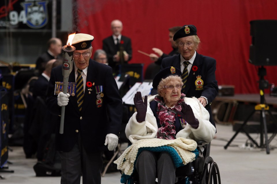 Roy Lamore, a navy veteran of the Second World War, with fellow veteran, 99-year-old Ida Maxwell, marched around the Fort William Gardens to pass off the torch to a current service member during the Remembrance Day Service. (Photos by Doug Diaczuk - Tbnewswatch.com). 