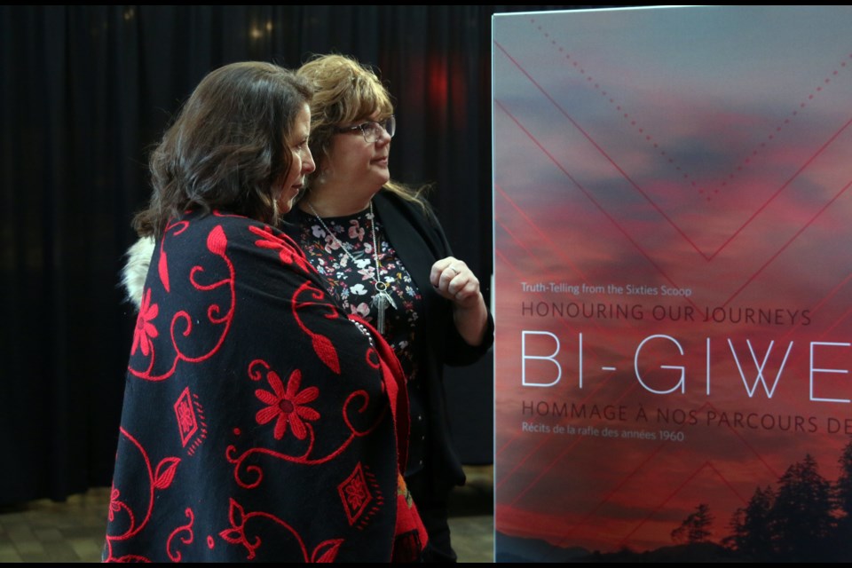 Denise Baxter (left), vice provost with Aboriginal Initiatives at Lakehead University and Fort William First Nation councilor, Michele Solomon, read one of the stories in the Bi-Giwen: Coming Home – Truth telling from the Sixties Scoop Exhibit at Lakehead University. 