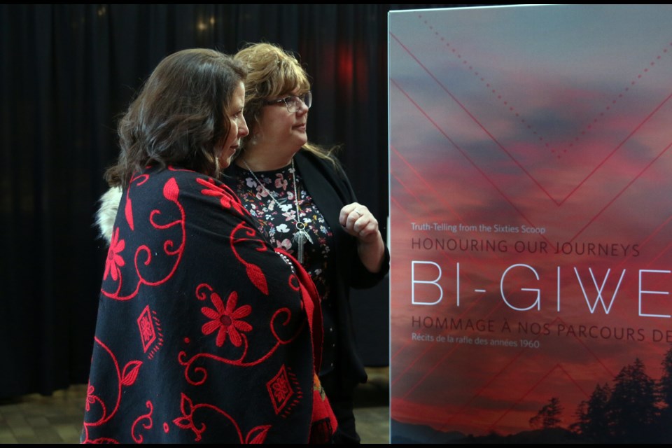 Denise Baxter (left), vice provost with Aboriginal Initiatives at Lakehead University and Fort William First Nation councilor, Michele Solomon, read one of the stories in the Bi-Giwen: Coming Home – Truth telling from the Sixties Scoop Exhibit at Lakehead University. 