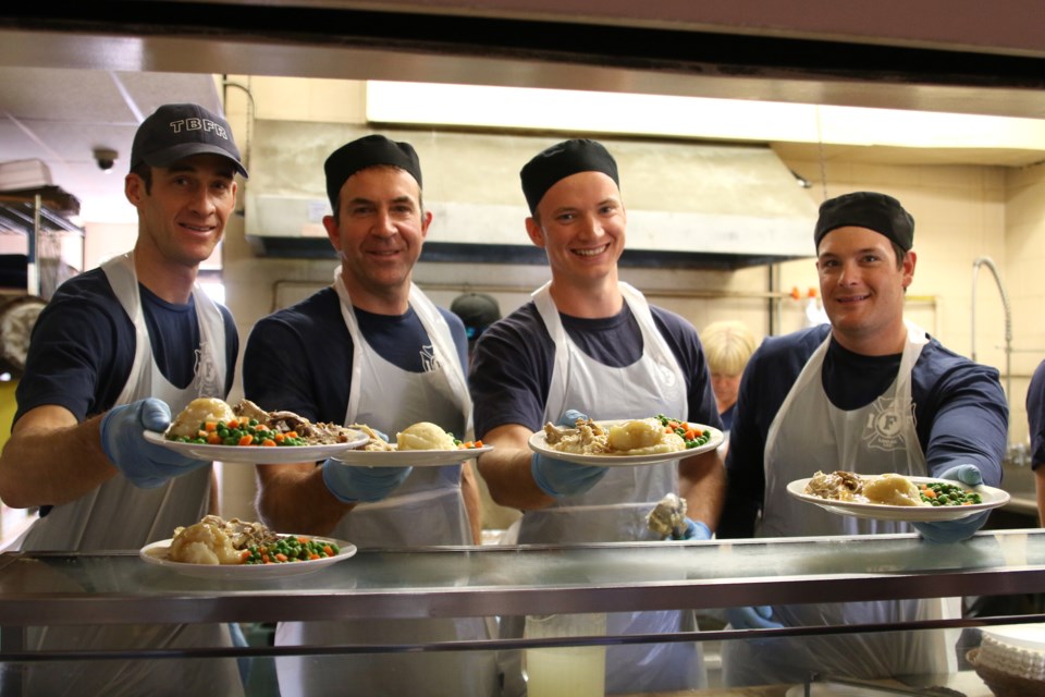 From left to right: Thunder Bay Fire Rescue members Matt Agar, Greg Stiletto, Rob Sheppard, DJ Folino were busy serving up a Thanksgiving feast at the Salvation Army on Sunday. (Photos by Doug Diaczuk - Tbnewswatch.com). 