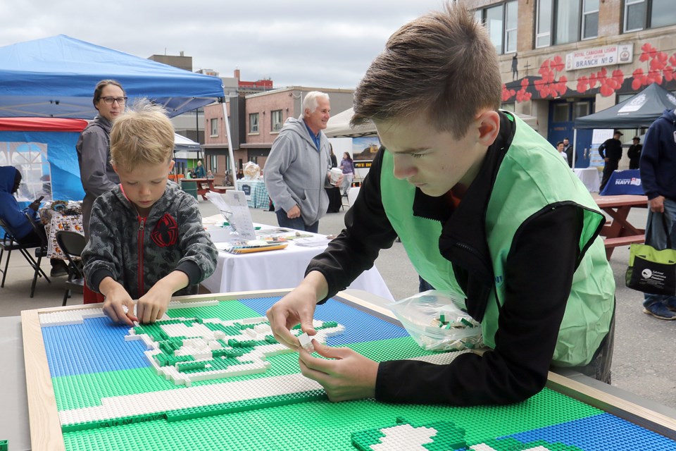 Volunteers and visitors helped put together a lego version of the French Canadian flag on Saturday, Sept. 14, 2019 at the Franco Festival on Van Norman Street. (Leith Dunick, tbnewswatch.com)