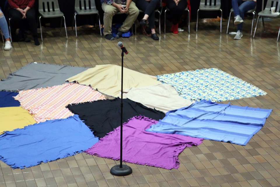 During the exercise, participants walk on blankets that symbolize the land and step into the role of First Nation, Inuit, and Metis peoples.