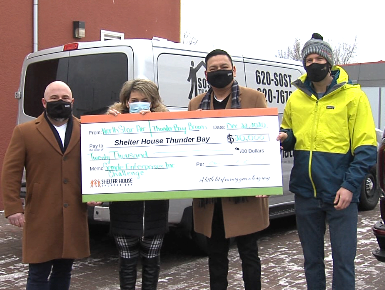 From left, Brent Massaro, Shelter House executive director Michelle Jordan, Titus Semple and Jeff Stout participate in a cheque presentation at Shelter House in Thunder Bay. (Cory Nordstrom/TBTV photo)