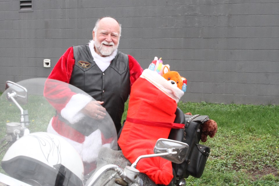 Michael Abbott wears a Santa costume and completed the ride with a stocking of toys. (Michael Charlebois, tbnewswatch)