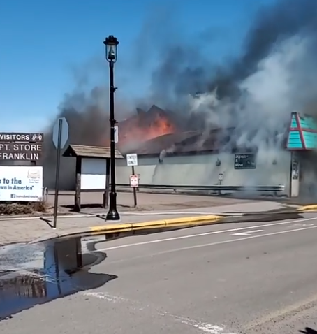 Flames could be seen bursting out of the rear of the Crooked Spoon restaurant and Picnic and Pine gift shop (Facebook/WTIP)