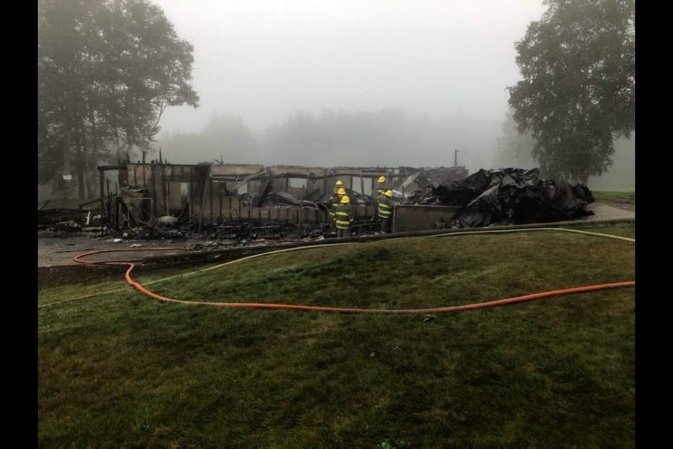 Firefighters inspect the remains of the Peninsula Golf Course clubhouse in Marathon, Ont. on Aug. 10, 2020