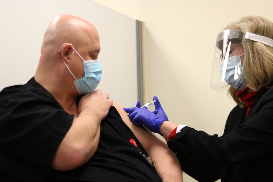 Sean Bolton, who has been a PSW for 19 years, rolled up his sleeve to receive the first Pfizer COVID-19 vaccine in the city of Thunder Bay. (Photos by Doug Diaczuk - Tbnewswatch.com). 