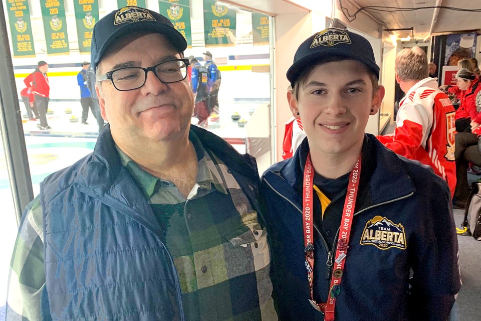 Team Alberta's Jacob Striker (right) and his coach and grandfather, Don, celebrate winning 2020 Special Olympics Canada Winter Games curling gold on Saturday, Feb. 29, 2020 at the Fort William Curling Club. (Leith Dunick, tbnewswatch.com)
