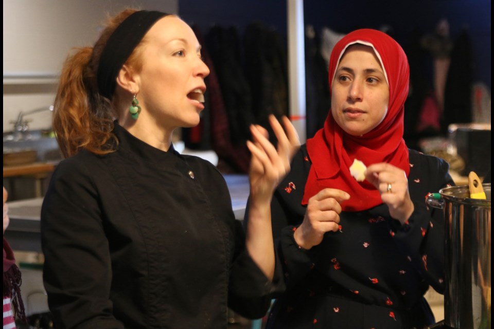 Rhonda Bill (left) of Fine Fit Catering and Mona Elmahdy, taste some ingredients during a class at the Culture Kitchen project with Roots to Harvest, which was one of the recipients of a grant to support gender equality. (Photos by Doug Diaczuk - Tbnewswatch.com). 