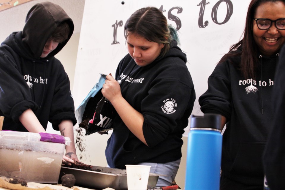 Roots to Harvest students make seed bombs at Seedy Saturday. (Photos by Ian Kaufman, tbnewswatch.com)