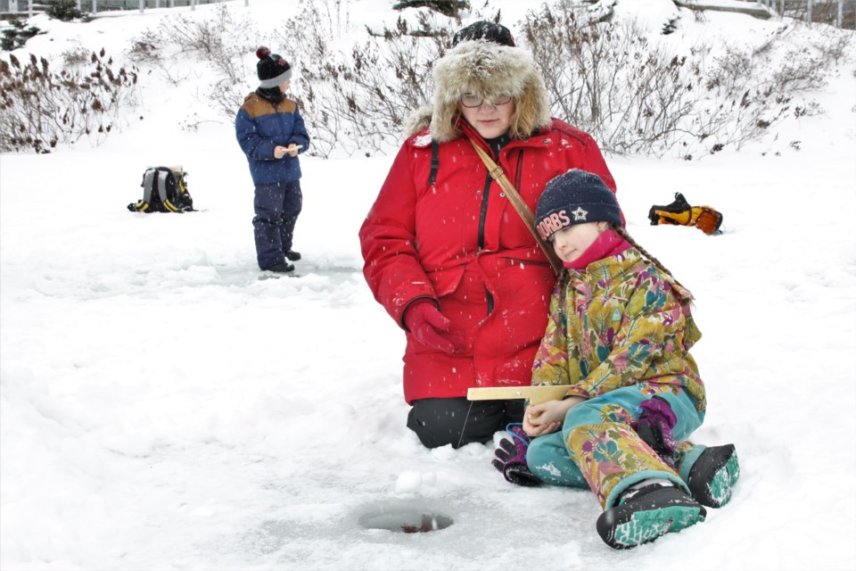Christmas Norris and her daughter Caly try their hand at ice fishing. (Photos by Ian Kaufman, tbnewswatch.com)
