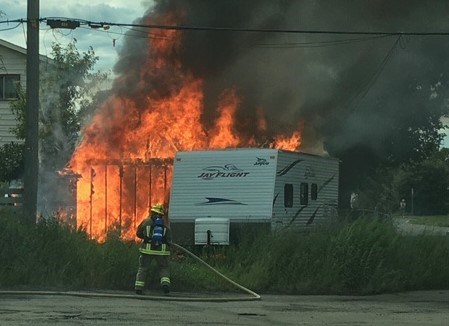 Thunder Bay Fire Rescue crews battle a garage and RV fire at an Alberta Street residence. (Thunder Bay Fire Rescue photo)