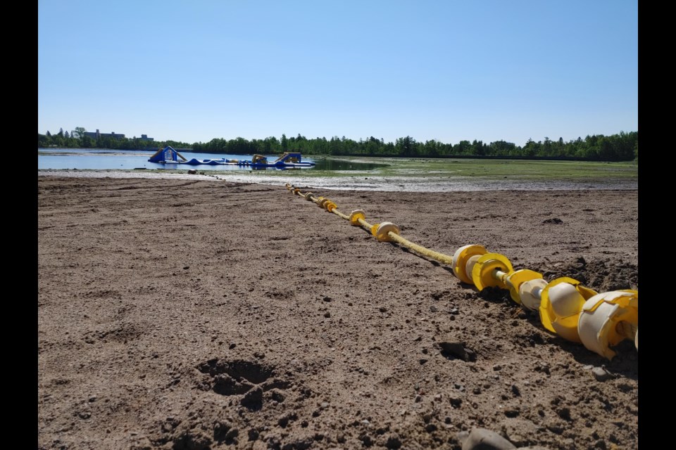 Residents of the Current River area woke up on June 27, 2022 to find Boulevard Lake had been unexpectedly drained. A floating water park - seen in the background - opened at Boulevard on the weekend (Leigh Nunan/TBTV photo)