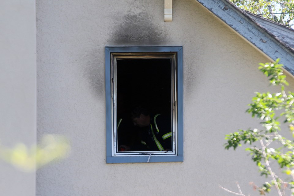 Thunder Bay Fire Rescue crews inspect the damage after a house fire at a Van Horne Street residence. (Leith Dunick, tbnewswatch.com)